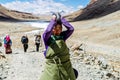 Tibetan woman commits bark around Mount Kailash. Royalty Free Stock Photo