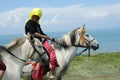 Tibetan woman riding horse