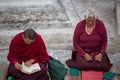 Tibetan women monk praying at the Boudhanath Stupa Royalty Free Stock Photo