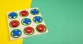 Tic-tac-toe board game concept on yellow and green background Royalty Free Stock Photo