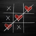 Tic tac toe game with chalk hearts, XO noughts and crosses Valentine`s Day style Royalty Free Stock Photo