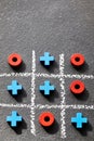 Tic tac toe game noughts and crosses on dark background. Royalty Free Stock Photo