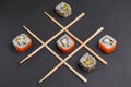 Tic tac toe game with sushi on dark black background, creative concept sushi rolls. Banner, playing tic tac toe game