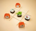 Tic tac toe game with sushi on orange background, creative concept sushi rolls. playing tic tac toe game