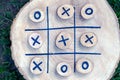 Tic tac toe game on a wooden board with wooden tac toe and crosses. winner strategy, winning skill, vision of an idea, ability to Royalty Free Stock Photo
