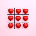 Tick tack toe made from red heart on pink background