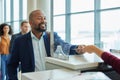 Ticket check, counter and black man in airport line for passport or travel service. Happy customer person at security or