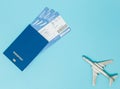 Tickets for plane and passport, dollars with model of plane on blue background. Copy space for text Royalty Free Stock Photo