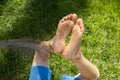 tickle the child s bare feet with a large ostrich feather Royalty Free Stock Photo