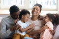 Affectionate black parents tickling and giggling with children at home Royalty Free Stock Photo