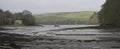 Tidal estuary at low tide: boats moored at anchor; mud; ruined lime kiln buildings