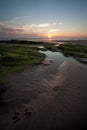 Tidal pools on beach with sunrise sunset