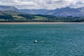 Tidal water of Menai Strait and Snowdonia mountains in the background