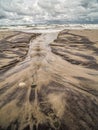 Tidal watercourse and marks on the beach