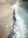 Tidal wave and rocky sand Royalty Free Stock Photo