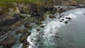 Tidal waves of the Atlantic Ocean near coast of the island of Ireland. Rocky seashore. Seascape, top view. Aerial photo