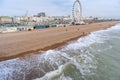 Tidal waves from the English channel move across the famous pebbled beach,overlooked by the now dismantled Brighton wheel, during