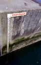 Tide gauge or tide staff on a harbour wall, showing chart datum, used by boats to determine water depth