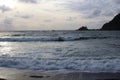 The tide of the Pacific Ocean coming in on a stormy evening at the black sand beach of Hana Bay, Hana, Maui Royalty Free Stock Photo