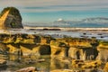 The tides out at Tongaporutu beach exposing the rock ledges Royalty Free Stock Photo