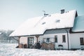 Tidy brick home after a winter snowfall.