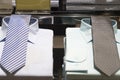 Tidy stacked luxurious shirts with beautiful ties on them