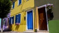 Tidy well-kept houses colored in bright vivid colors decorated with flowers