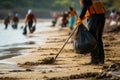 Tidying up the beach: Volunteers use rakes to collect trash.