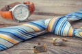 Tie, cufflinks and watches on the old wood background