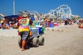 A tie dyed shirt man sells ice cream to the summer beach crowd Royalty Free Stock Photo