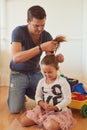 Tie, home or father with child for hair, support or help to get ready for school or kindergarten. Girl ponytail, prepare Royalty Free Stock Photo