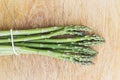 Tied asparagus spears on chopping board Royalty Free Stock Photo