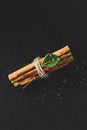 Tied bundle of cinnamon sticks on black background Royalty Free Stock Photo