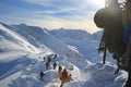 Tied climbers climbing mountain with snow field tied