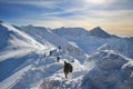 Tied climbers climbing mountain with snow field tied