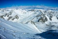 Tied climbers climbing mountain with snow field tied with a rope with ice axes and helmets