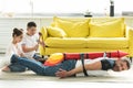 tied father with rocket toy lying on floor and disobedient children Royalty Free Stock Photo