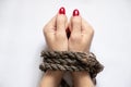 Tied female hands with rope on white background close-up Royalty Free Stock Photo