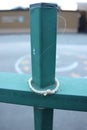 Tied rope hung on spike of green school metal gates