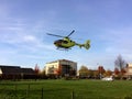 TIEL, THE NETHERLANDS - NOVEMBER 14, 2018: Yellow medical helicopter taking off after assisting in medical aid in residential area Royalty Free Stock Photo