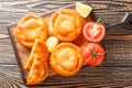 Tielle Setoise small spicy pie of octopus in tomatoes closeup on a wooden board. Horizontal top view Royalty Free Stock Photo