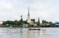 Tien Giang, Vietnam - Nov 28, 2014: Tien river scene in Mekong Delta, with rowing boats and church on background