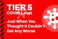 TIER 5 - COVID level Just when you thought it couldn\'t get any worse - Illustration with virus logo on a red background