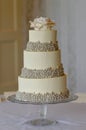 3 tier wedding cake with silver pearls and edible rose flower to Royalty Free Stock Photo