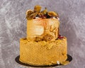 Tiered cake decorated in an autumn theme in gold color