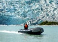 Zodiac boats from Ventus Australis expedition ship transfer tourists on the shore near Pia glacier in Patagonia