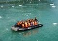 Zodiac boats from Ventus Australis expedition ship transfer tourists on the shore near Pia glacier in Patagonia