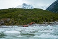Zodiac boats from Ventus Australis expedition ship transfer tourists on the shore near Pia glacier in Patagonia