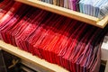 Ties of red shade and warm tones with strict design pattern are folded in row in the window of fashionable mens clothing store Royalty Free Stock Photo