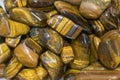 Tiger Eye Stones Ready to Make Handmade Jewelry. tiger`s eye and hawk`s eye gemstone as natural mineral rock specimen Royalty Free Stock Photo